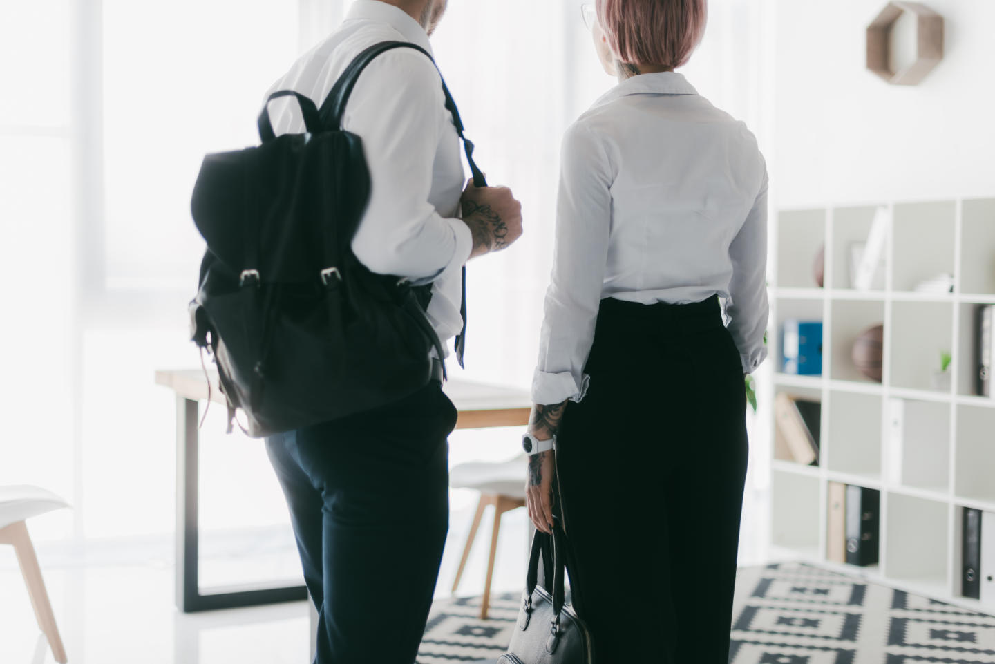 Cropped shot of young couple in formal wear leaving office toget