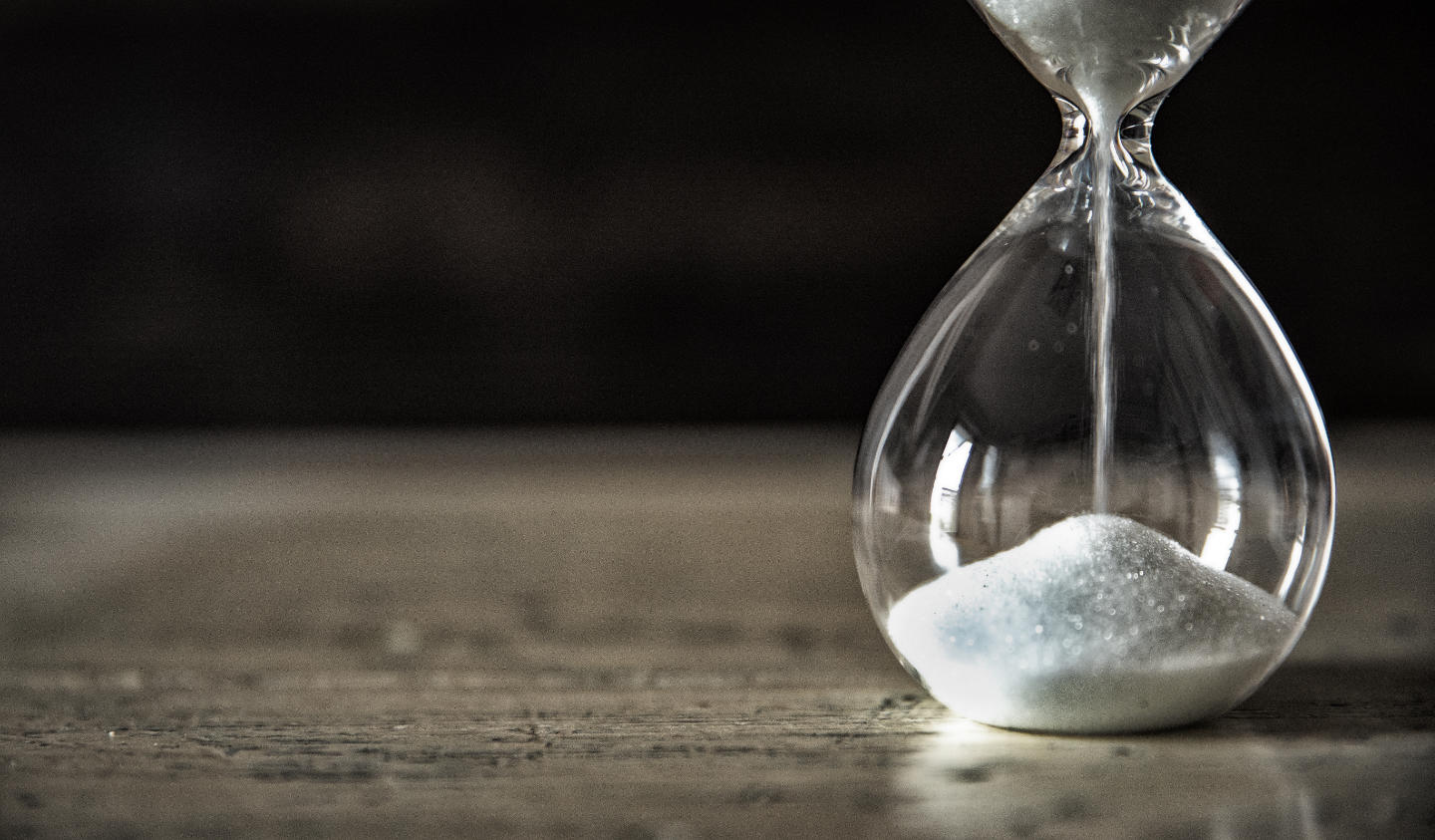 Dramatic sand timer on wooden table